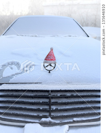 Decorating the car for the new year and Christmas. Santa's red cap. Close up vertical photo Decorating the car for the new year and Christmas. Santa's red cap. Close up vertical photo 135646910