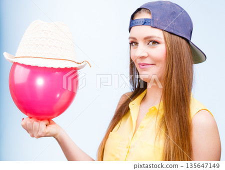Happy teenage girl with red balloon. 135647149