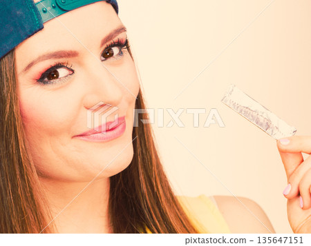 Woman eating chewing gum Woman eating chewing gum 135647151