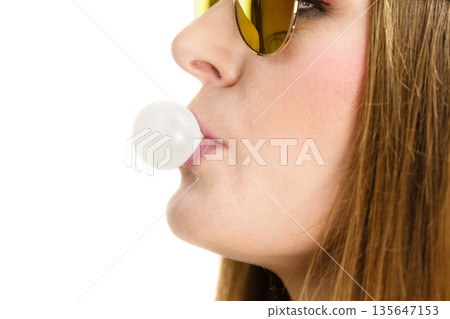 Woman doing bubble with chewing gum 135647153