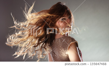 Mysterious enigmatic woman girl with flying hair. 135647488