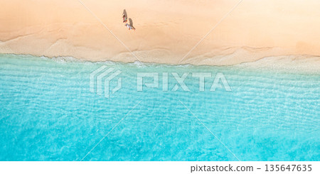 Summer aerial beach top view couple walking sandy shore calm waves landscape 135647635