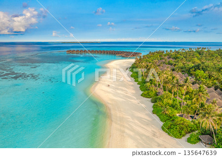 Breathtaking aerial view of tropical Maldives island beach during luxury summer vacation Breathtaking aerial view of tropical Maldives island beach during luxury summer vacation 135647639
