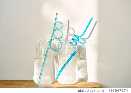 Refreshing summer drinks with ice and swirling straws Refreshing summer drinks with ice and swirling straws 135647674