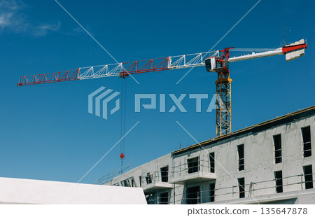 Red and white tower crane Red and white tower crane 135647878