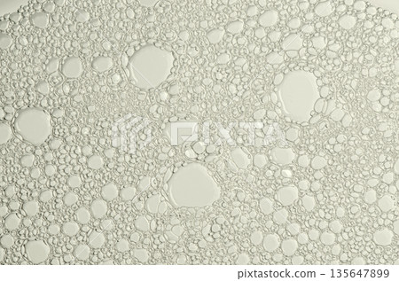 The texture of the foam of shower gel or soap suds. Macrophotography The texture of the foam of shower gel or soap suds. Macrophotography 135647899