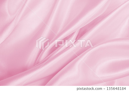 Smooth elegant pink silk or satin texture as wedding background. Luxurious background design Smooth elegant pink silk or satin texture as wedding background. Luxurious background design 135648184