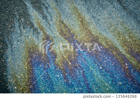 Oil, gasoline, and water creating a colorful, shimmering, abstract pattern on wet asphalt Oil, gasoline, and water creating a colorful, shimmering, abstract pattern on wet asphalt 135648268