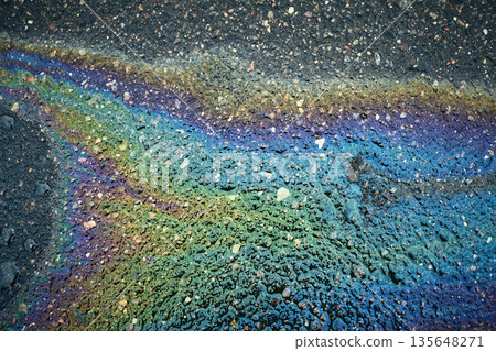 Oil Spills Create Colorful Patterns on the Street During a Rainy Day in an Urban Area Oil Spills Create Colorful Patterns on the Street During a Rainy Day in an Urban Area 135648271