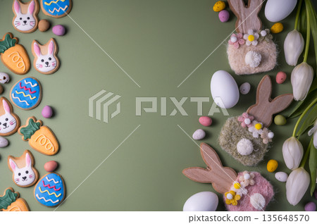 Easter spring holiday background with easter cookies: buny, carrot and egg with white tulip flowers, flat lay and copy space 135648570