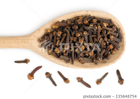dry spice cloves in wooden spoon isolated on white background. Top view. Flat lay 135648754