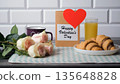Happy Valentines Day postcard beside croissants, orange juice, hot tea and roses 135648828