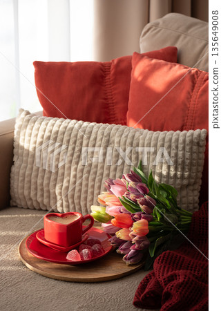 Heart Shaped Coffee Cup with Colorful Tulips and Candies. Cozy Romantic Flatlay on Sofa for Valentines Day Celebration 135649008