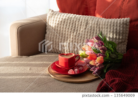 Heart Shaped Coffee Cup with Colorful Tulips and Candies. Cozy Romantic Flatlay on Sofa for Valentines Day Celebration 135649009