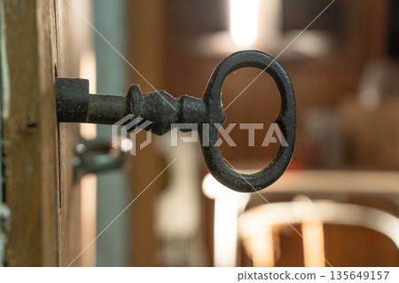 Antique key on door Antique key on door 135649157