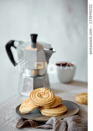 Mocha coffee pot and cookies 135649202