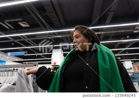 Person shopping in clothing store Person shopping in clothing store 135649245