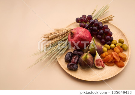 Seven species fruits and grains on wooden plate 135649433