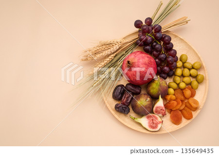 Displaying seven species traditional tu bishvat ingredients on tray Displaying seven species traditional tu bishvat ingredients on tray 135649435