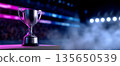 Silver trophy cup on a pedestal with colorful stadium lights and smoke in the background symbolizing victory and achievement 135650539