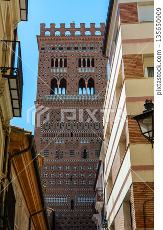 Mudejar Tower of El Salvador framed between buildings in Teruel Mudejar Tower of El Salvador framed between buildings in Teruel 135650909