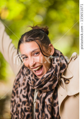 Young hispanic woman laughing expressing happiness outdoors 135651071