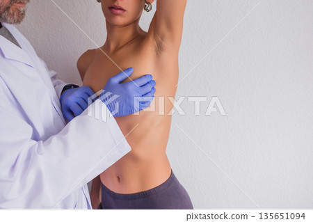 Doctor performing breast examination for breast cancer detection 135651094