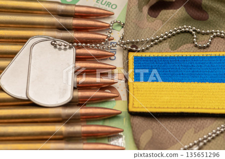 Ukrainian army symbolism with cartridges and European currency. 135651296