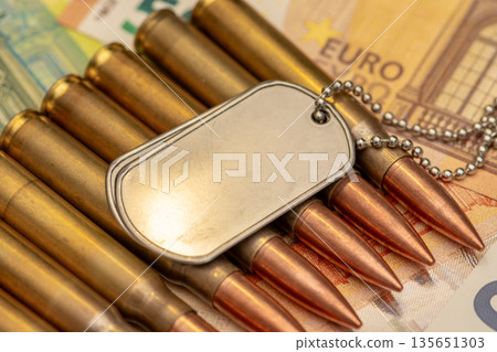 Identification tags and ammunition on euro currency 135651303