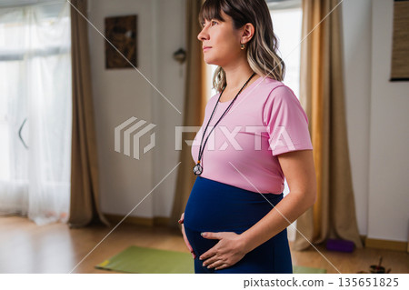 Pregnant woman practicing prenatal yoga for wellness 135651825