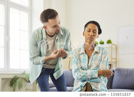 Man offers apology to upset wife or girlfriend during relationship conflict at home 135651837