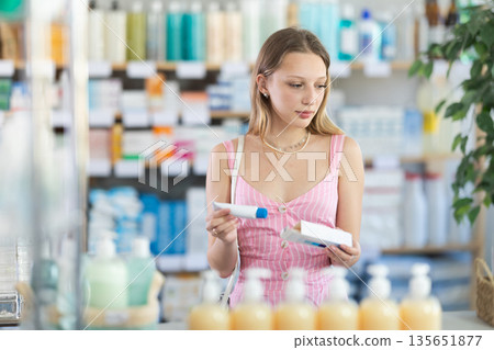 Young woman in summer dress buying ointment 135651877