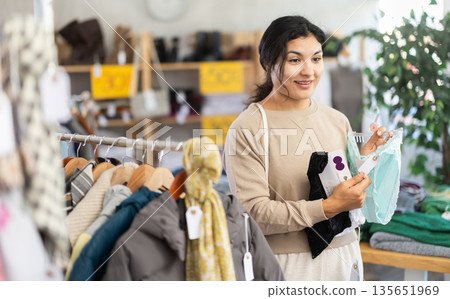 Latina woman choosing lingerie in a clothing store Latina woman choosing lingerie in a clothing store 135651969