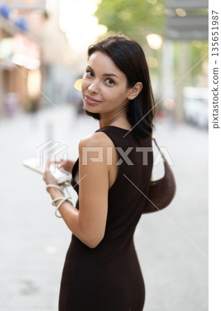 Stylish young woman walking with phone on Barcelona street Stylish young woman walking with phone on Barcelona street 135651987