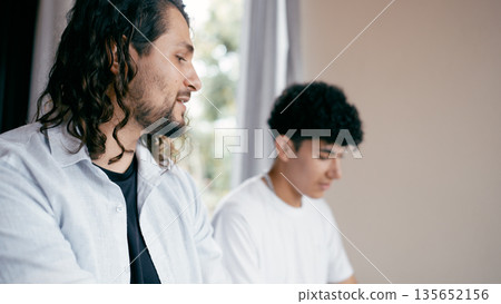 Teacher giving keyboard lesson to student at home 135652156