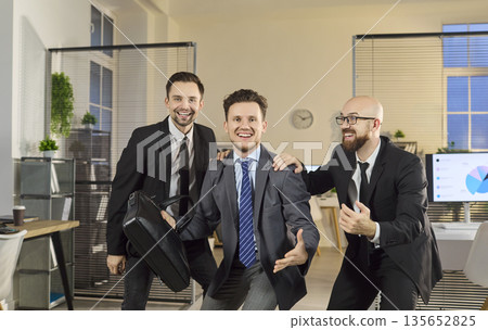 Happy businessmen team dancing in office celebrating success and teamwork energy Happy businessmen team dancing in office celebrating success and teamwork energy 135652825