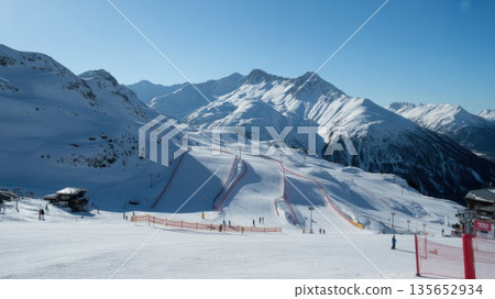 Sunny Alpine Ski Resort Features Empty Slopes and Mountains During the Winter Season 135652934