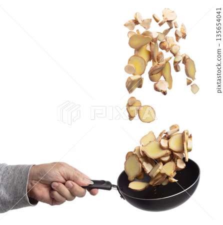 Galangal mix Ginger fall fly in pan, fresh vegetable spice ginger galangal falling. Organic fresh herbal ginger galangal root head cut chop slice. White background isolated freeze motion high speed Galangal mix Ginger fall fly in pan, fresh vegetable spice ginger galangal falling. Organic fresh herbal ginger galangal root head cut chop slice. White background isolated freeze motion high speed 135654041