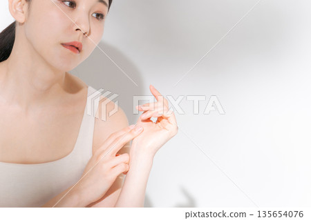 A young lady hitting his cheek 135654076