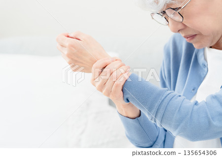 Senior woman with wrist pain 135654306