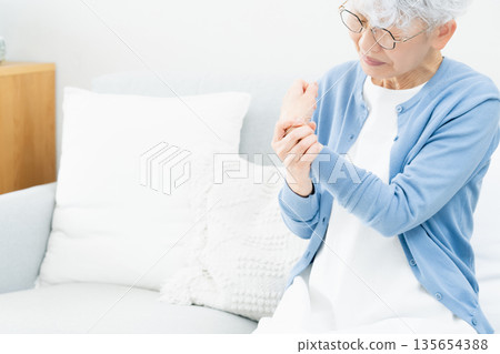 Senior woman with wrist pain Senior woman with wrist pain 135654388