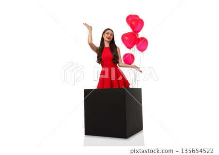 Woman in red dress holds pink balloons on cube, isolated, PNG Woman in red dress holds pink balloons on cube, isolated, PNG 135654522