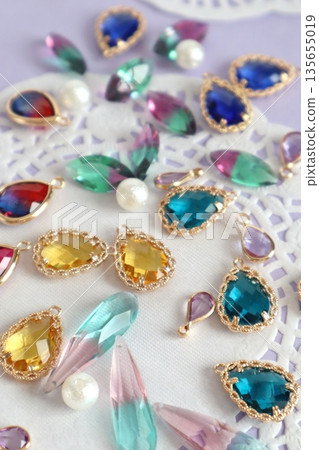 Colorful glass beads, cotton pearls and lace paper Colorful glass beads, cotton pearls and lace paper 135655019