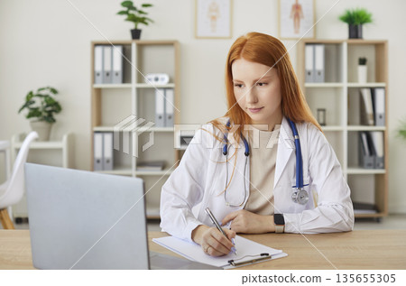 Female Doctor Or Nurse Working Online With Laptop In Clinic Office 135655305