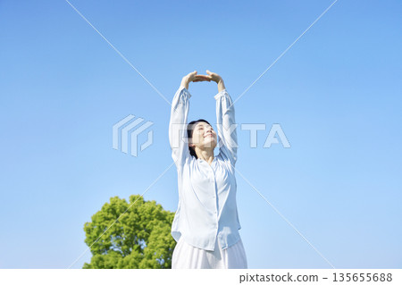 A woman stretching outdoors 135655688