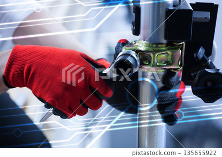 Close-up of construction worker's hands using pipe clamps etc. 135655922