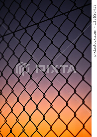 Twilight sky and chain link fence Twilight sky and chain link fence 135656415