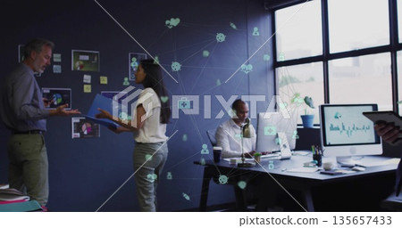 Gesturing team exchanging data at office meeting, with blue folder, charts, devices, network icons 135657433