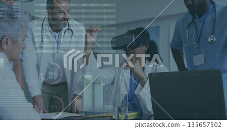 Female doctor exploring virtual charts at conference table with VR headset, laptop and stethoscopes Female doctor exploring virtual charts at conference table with VR headset, laptop and stethoscopes 135657502