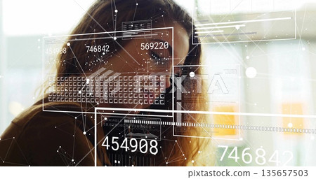 Analyzing adult woman reviewing data panels at office windows, showing graphs and network nodes 135657503